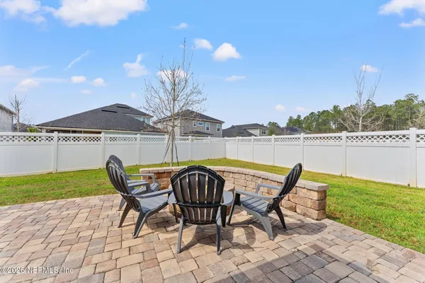 a view of a chairs and table on the patio