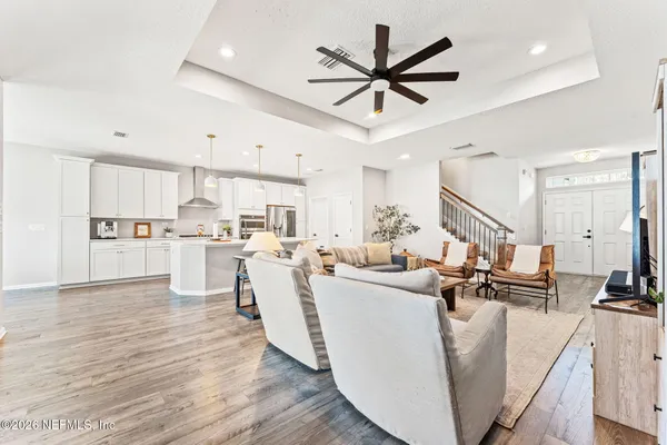 a living room with stainless steel appliances kitchen island furniture and a view of kitchen