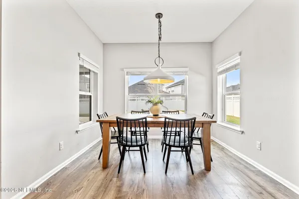 a view of a dining room with furniture window and wooden floor
