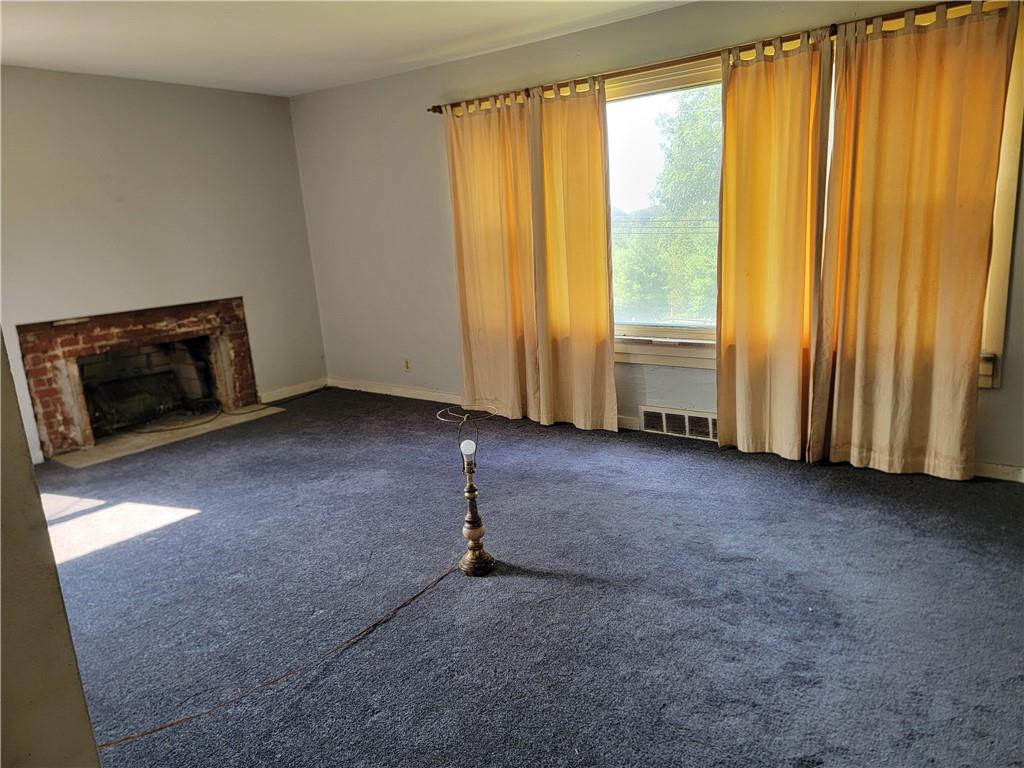 421 Hays Road Venetia, PA 15367 - Photo 6 of 28 a view of an empty room with a fireplace and a window