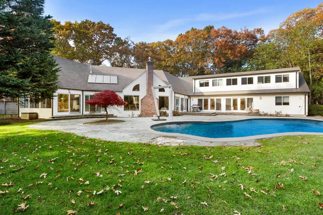 a front view of a house with a yard table and chairs