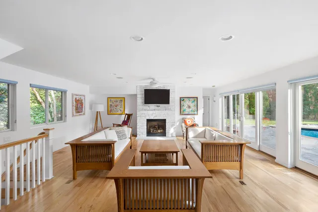 a living room with furniture a fireplace and a flat tv screen