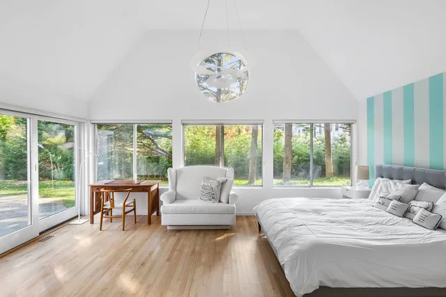 a bedroom with a large bed and a large window