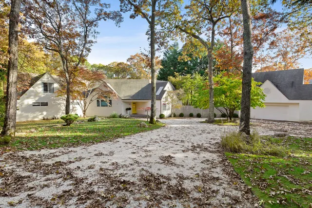 a view of a house with a yard and tree s