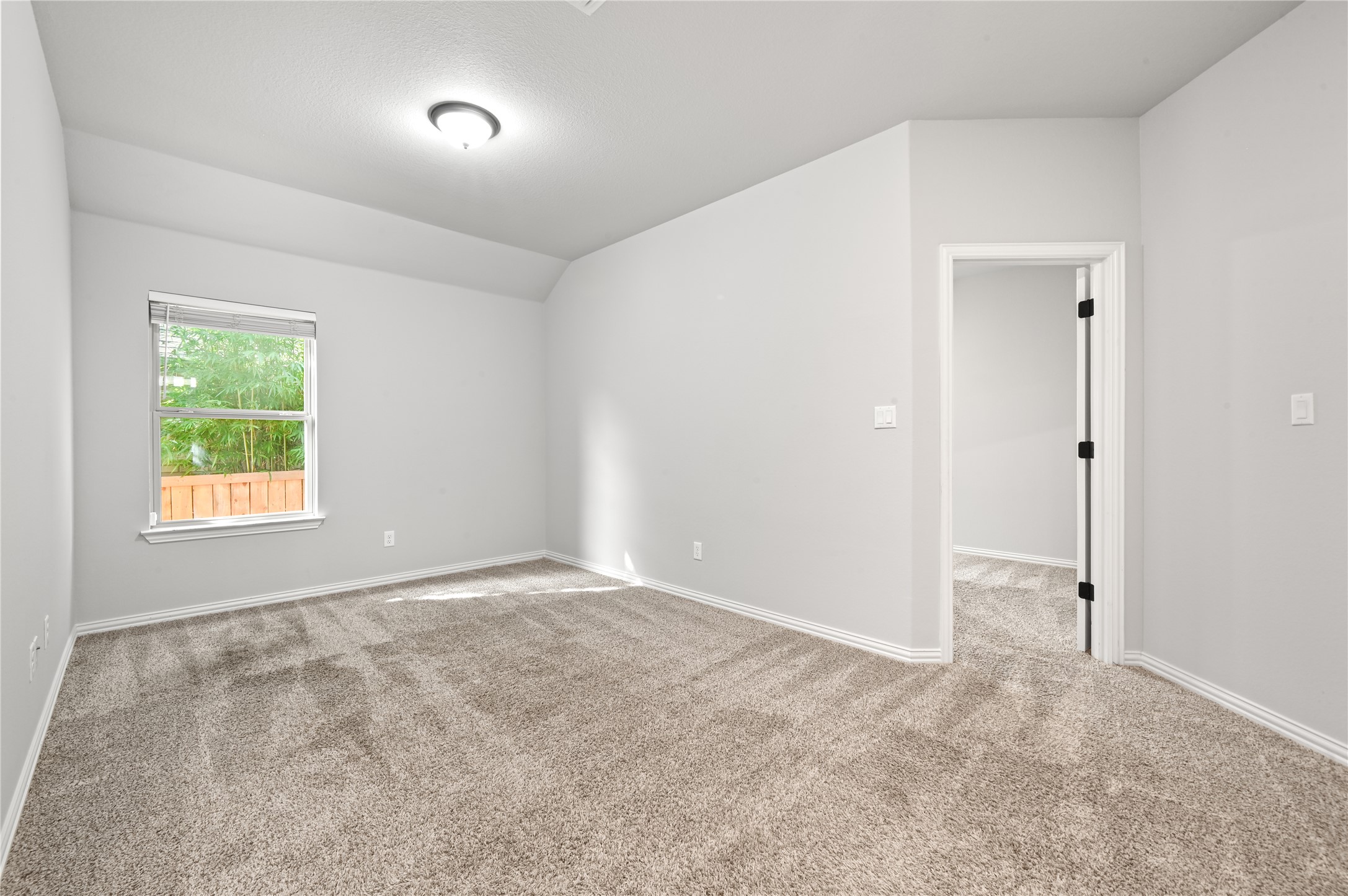 426 Cold Riv Run Kyle, TX 78640 - Photo 20 of 34 A quiet retreat with plush carpeting and natural light filtering through a generous window.