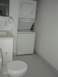 a white toilet sitting next to a sink