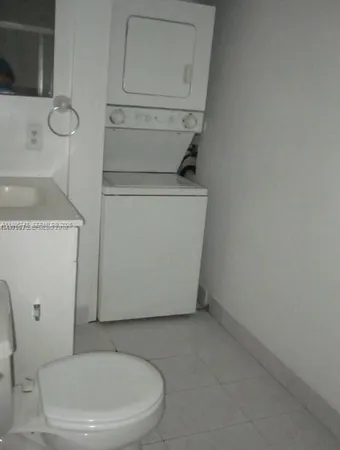 a white toilet sitting next to a sink