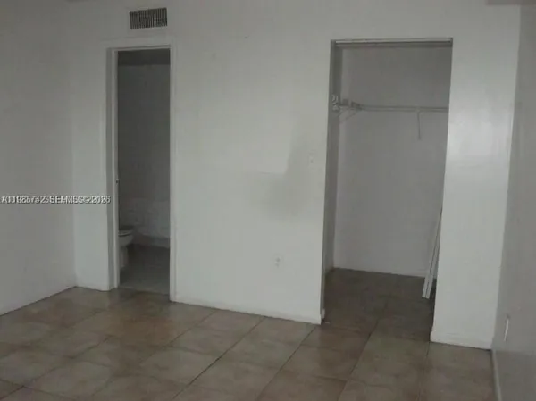 an empty room that has a grey walls