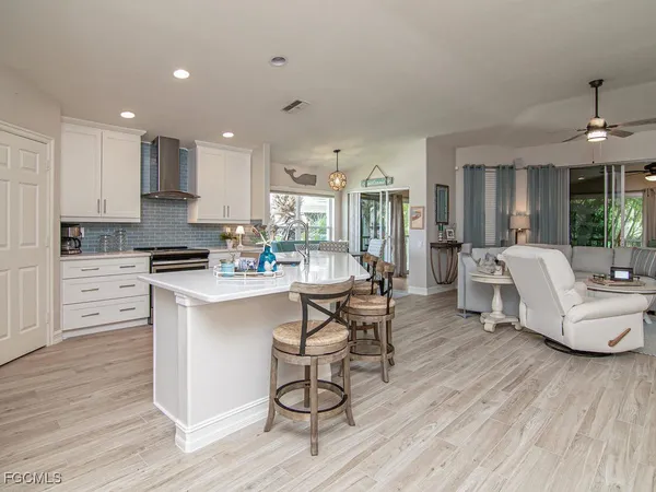 a living room with kitchen island furniture and a wooden floor