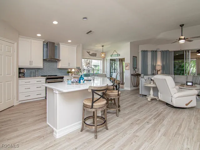 a living room with kitchen island furniture and a wooden floor