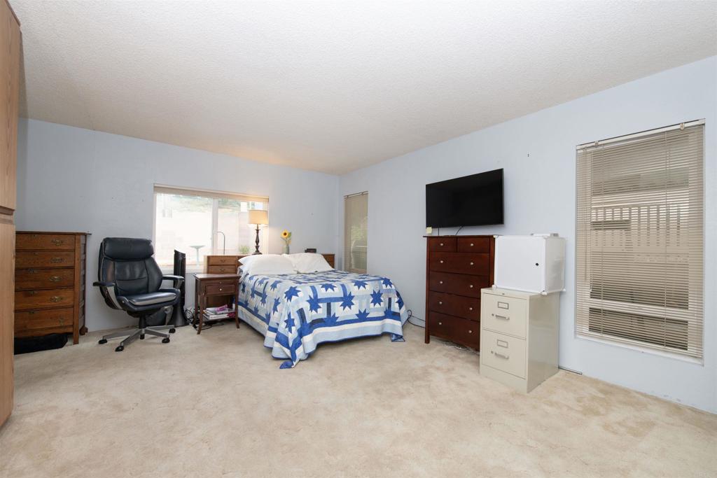 909 Richland Road, Unit 79 San Marcos, CA 92069 - Photo 11 of 17 a bedroom with a bed and furniture