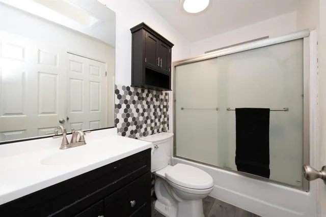 a bathroom with a sink toilet and shower