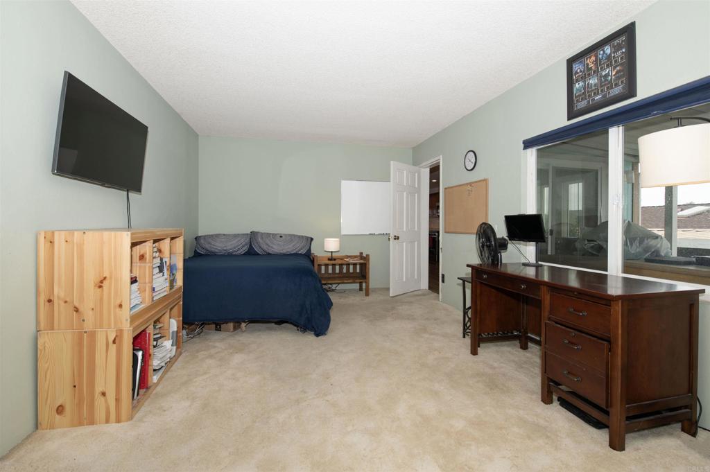 909 Richland Road, Unit 79 San Marcos, CA 92069 - Photo 9 of 17 a room with furniture and flat screen tv