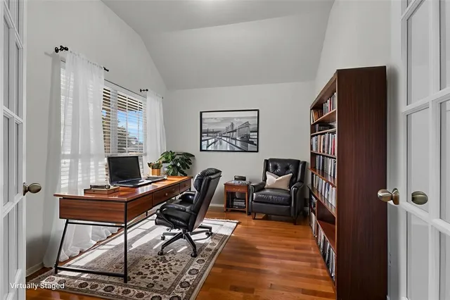 a view of a workspace with furniture and a window