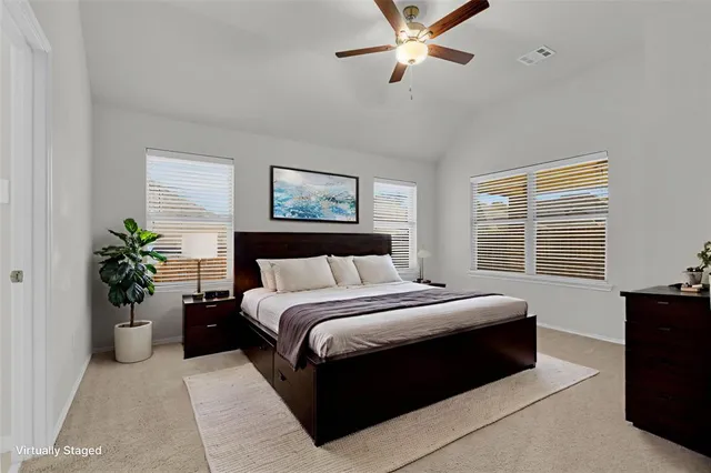 a bed room with a bed and a potted plant