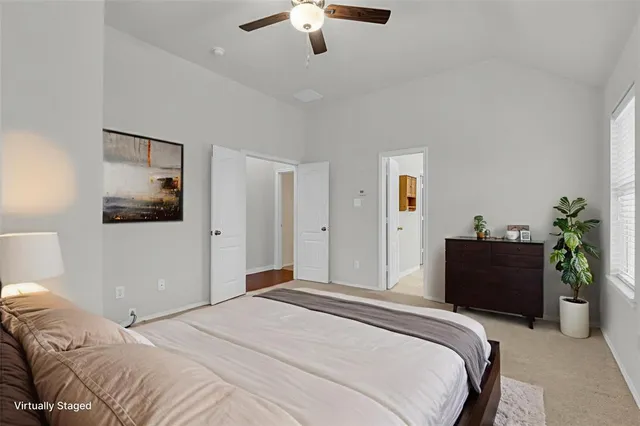 a bedroom with a bed and a potted plant