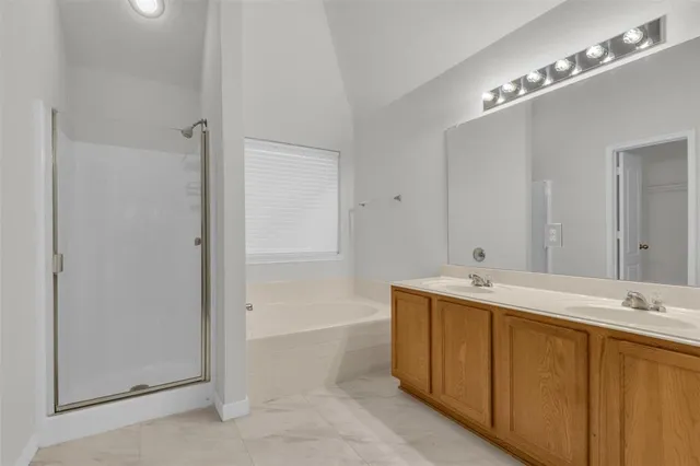 a bathroom with a tub sink and mirror