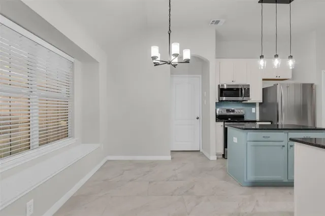 a view of a kitchen with electric appliances