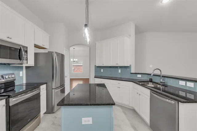 a kitchen with a sink a stove and refrigerator