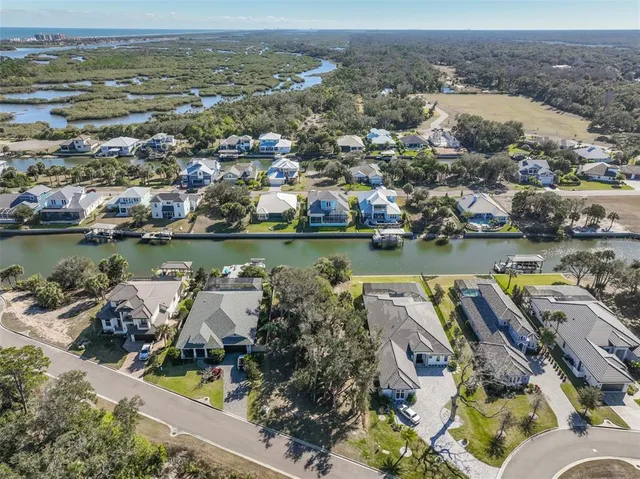 an aerial view of a house with a ocean view