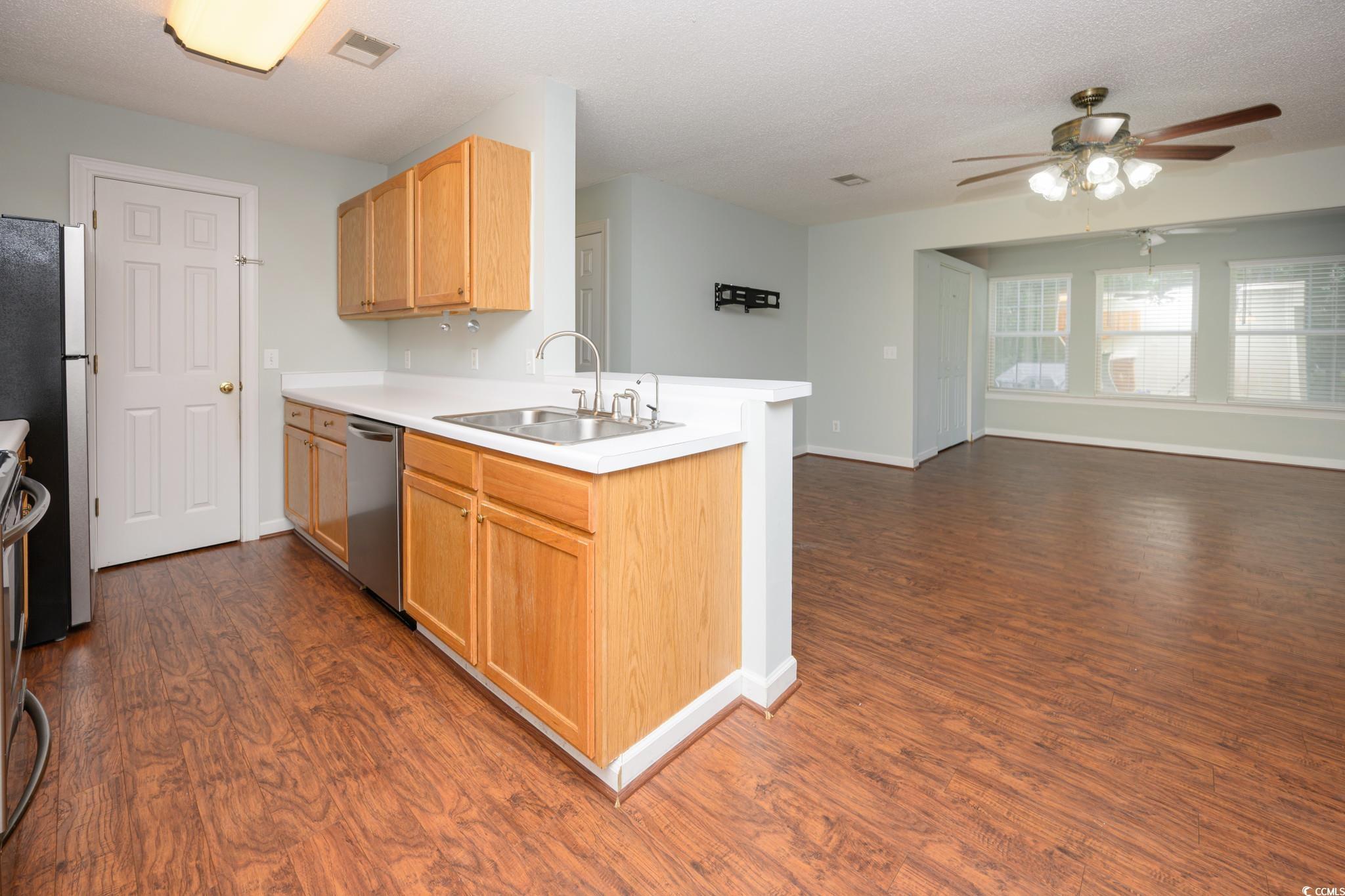 4283 Santolina Way, Unit D Murrells Inlet, SC 29576 - Photo 31 of 31 Kitchen featuring light brown cabinetry, light countertops, open floor plan, a ceiling fan, and a textured ceiling
