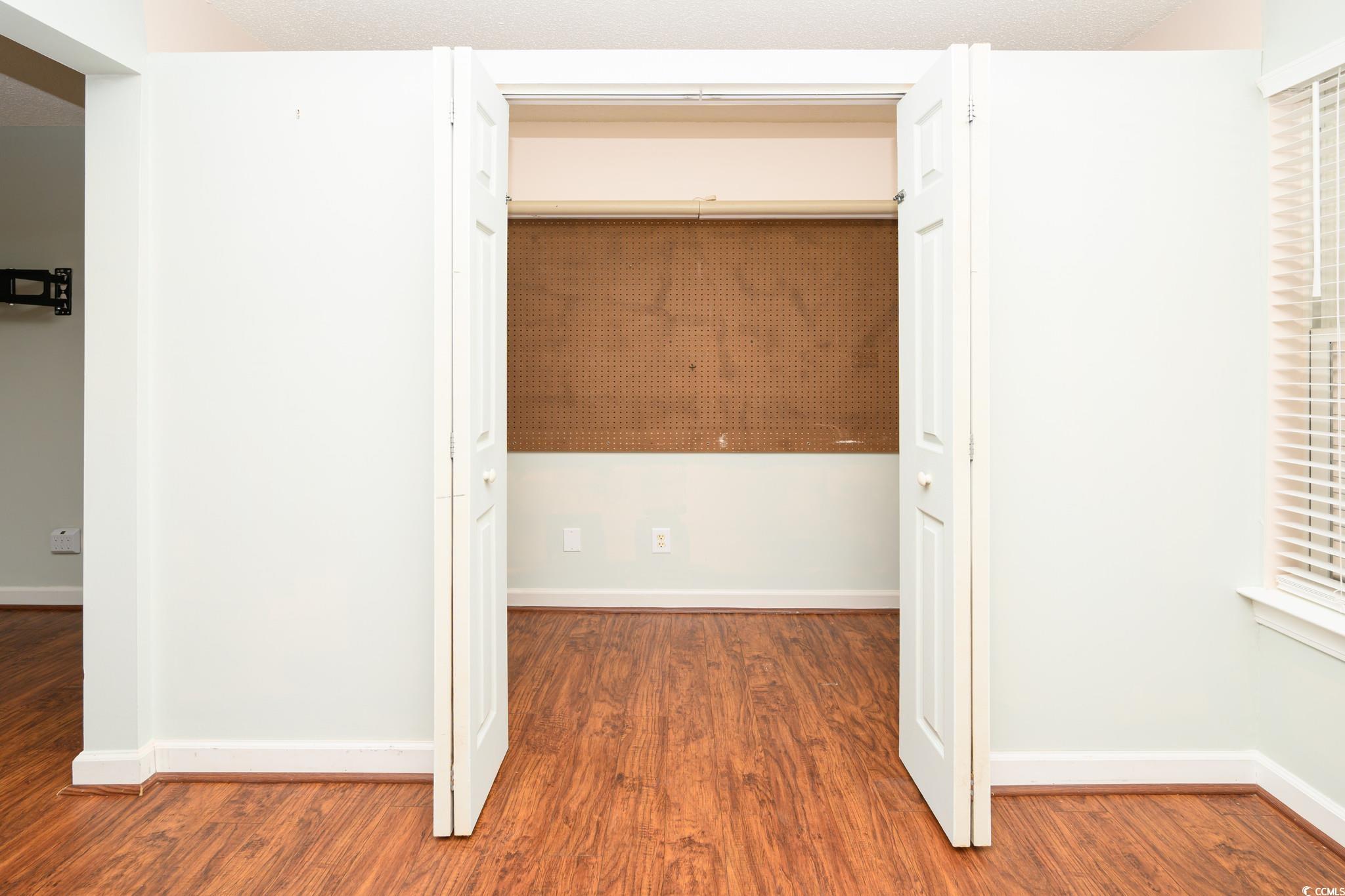 4283 Santolina Way, Unit D Murrells Inlet, SC 29576 - Photo 8 of 31 Hallway featuring dark wood-style flooring and baseboards