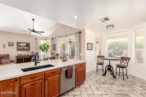 a large kitchen with kitchen island a sink dining table and chairs