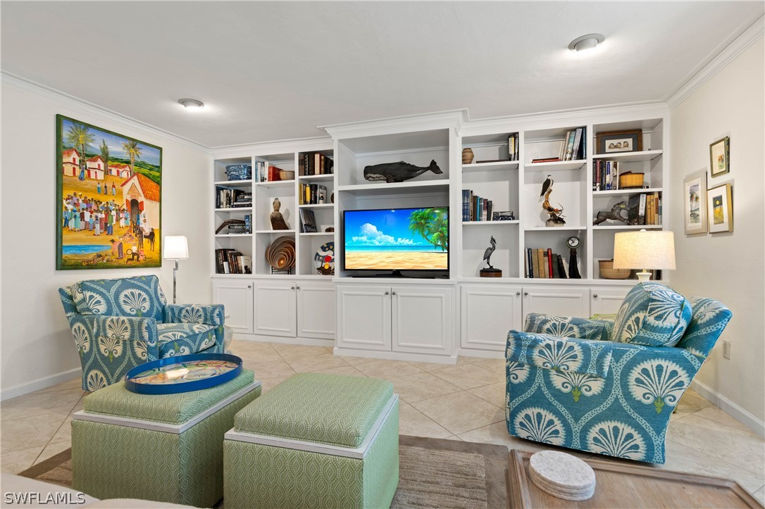975 Sand Castle Road Sanibel, FL 33957 - Photo 12 of 24 a living room with furniture and a book shelf