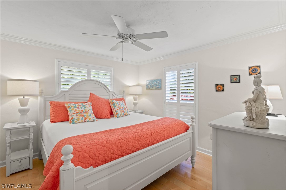 975 Sand Castle Road Sanibel, FL 33957 - Photo 17 of 24 a bedroom with a large bed and a chandelier