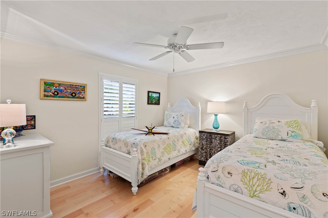 975 Sand Castle Road Sanibel, FL 33957 - Photo 19 of 24 a bedroom with two beds and painting on the wall