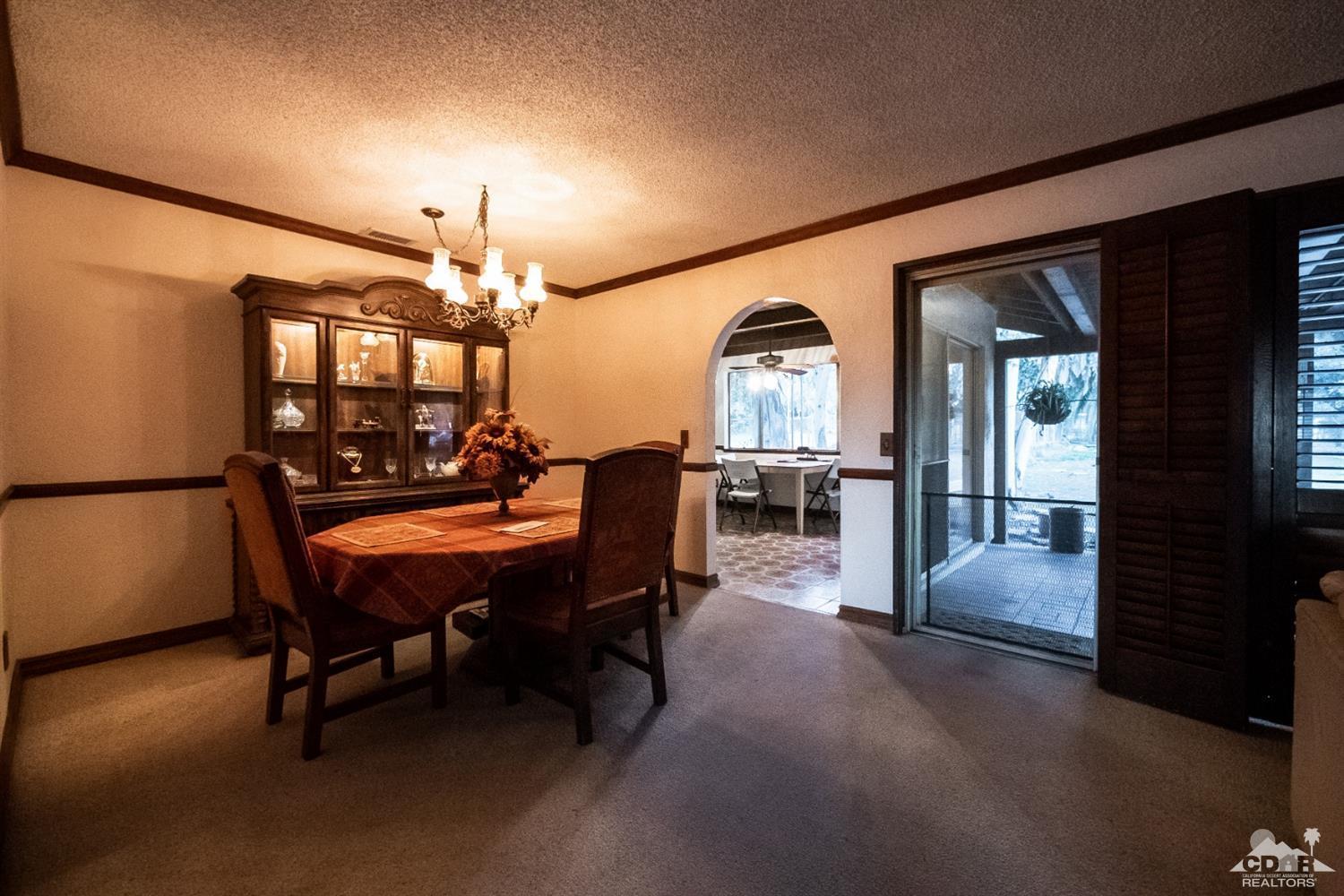 2132 John Street Riverside, CA 92503 - Photo 35 of 52 a dining room with furniture and chandelier