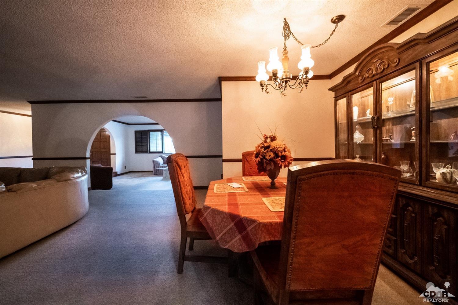 2132 John Street Riverside, CA 92503 - Photo 36 of 52 a dining room with furniture and a chandelier