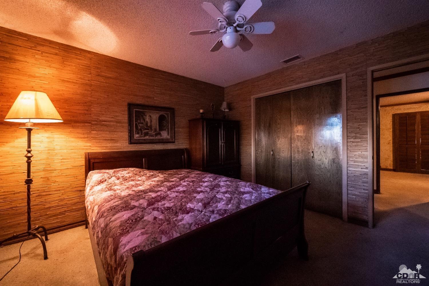 2132 John Street Riverside, CA 92503 - Photo 37 of 52 a bedroom with a bed and a chandelier