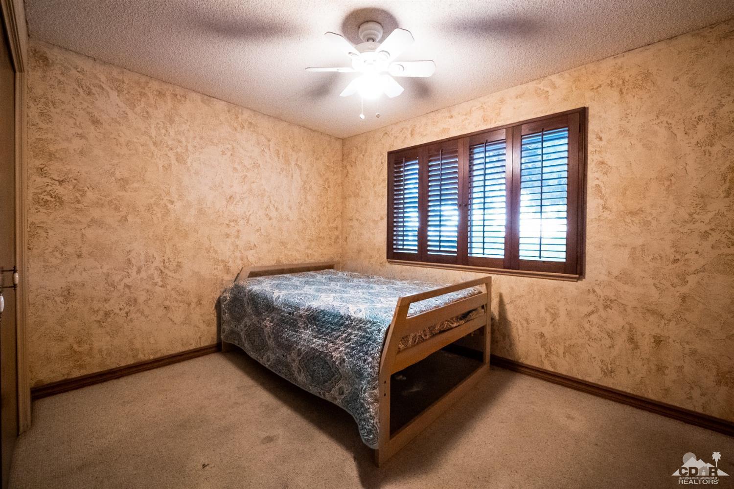 2132 John Street Riverside, CA 92503 - Photo 39 of 52 a bedroom with a bed and a chandelier