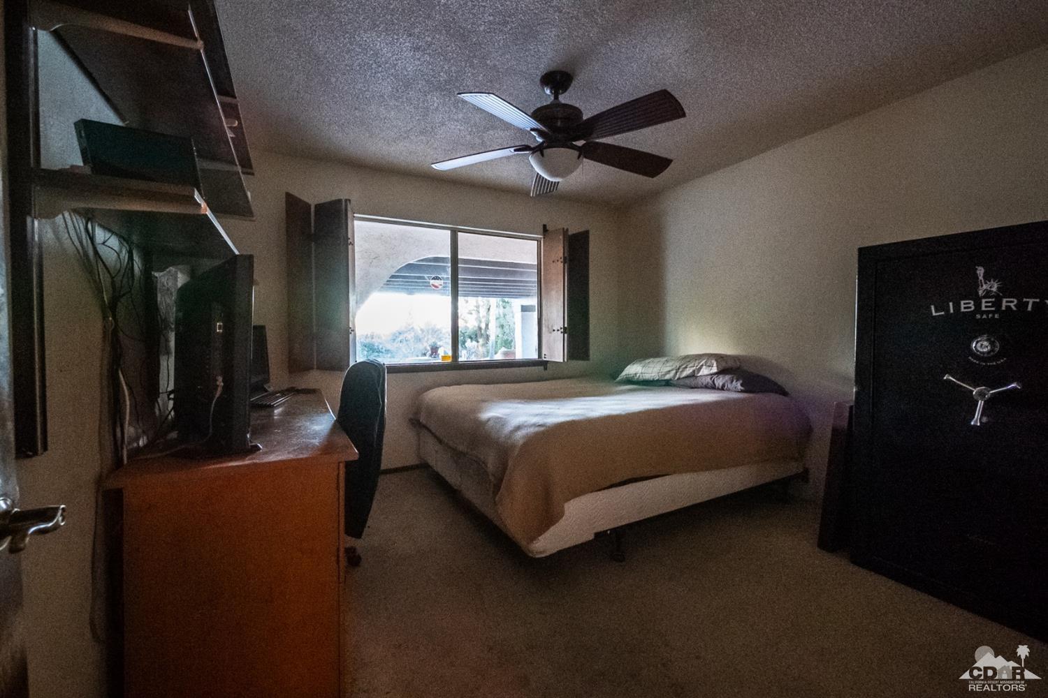 2132 John Street Riverside, CA 92503 - Photo 42 of 52 a bedroom with a bed and a ceiling fan