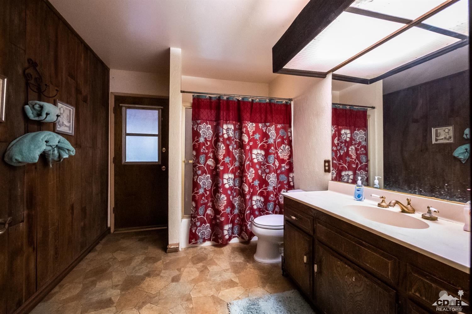 2132 John Street Riverside, CA 92503 - Photo 46 of 52 a bathroom with a sink a toilet and shower curtain