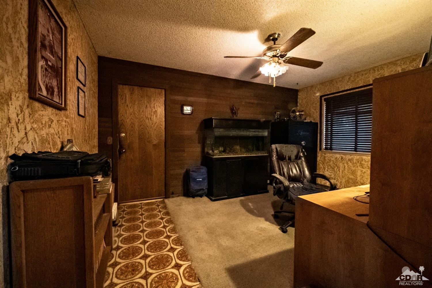 2132 John Street Riverside, CA 92503 - Photo 9 of 52 a bedroom with a bed and a chandelier