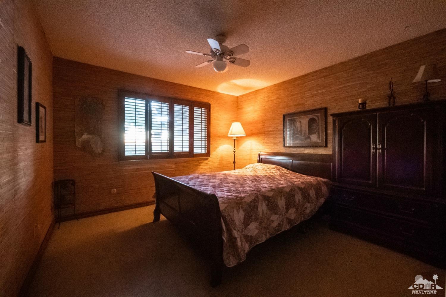 2132 John Street Riverside, CA 92503 - Photo 10 of 52 a spacious bedroom with a bed and a chandelier