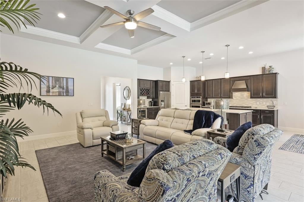 9431 Greyhawk Trail Naples, FL 34120 - Photo 11 of 50 a living room with furniture kitchen view and a chandelier