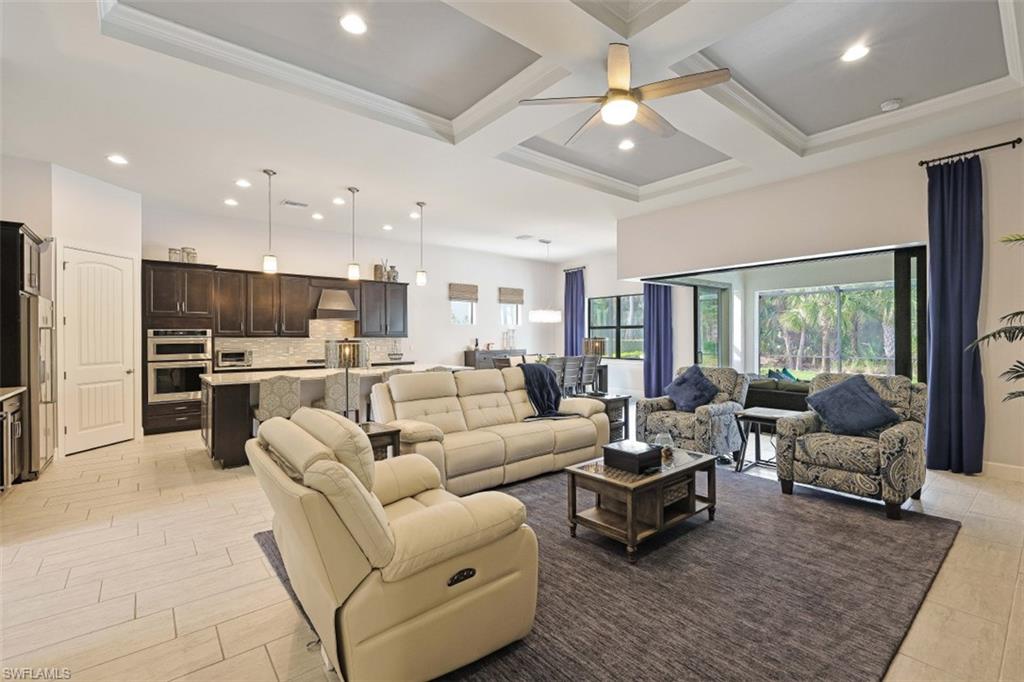 9431 Greyhawk Trail Naples, FL 34120 - Photo 12 of 50 a living room with furniture kitchen view and a large window
