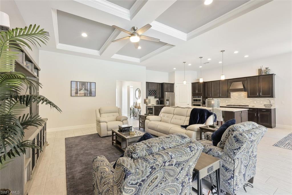 9431 Greyhawk Trail Naples, FL 34120 - Photo 13 of 50 a living room with furniture and a flat screen tv