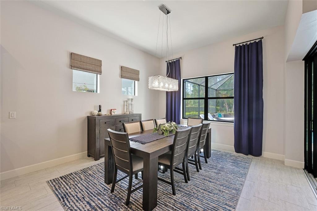 9431 Greyhawk Trail Naples, FL 34120 - Photo 15 of 50 a view of a dining room with furniture window and wooden floor