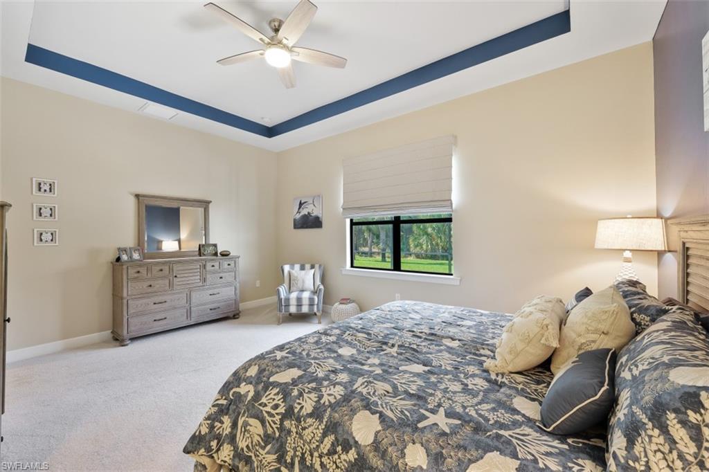 9431 Greyhawk Trail Naples, FL 34120 - Photo 18 of 50 a bedroom with a bed and a couch