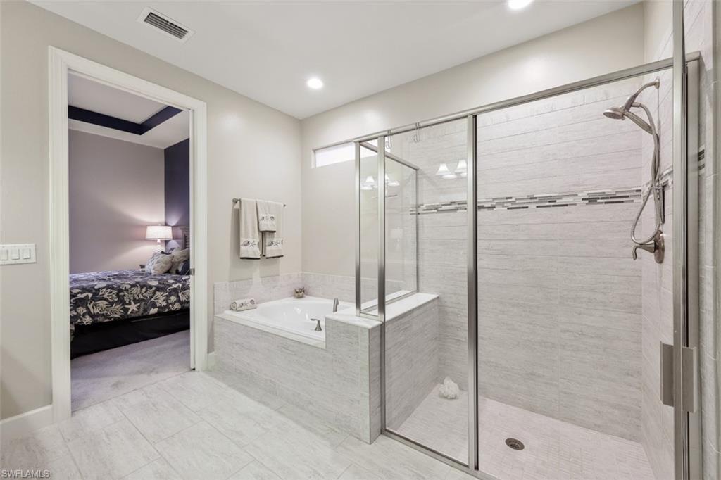 9431 Greyhawk Trail Naples, FL 34120 - Photo 20 of 50 a bathroom with a tub and shower