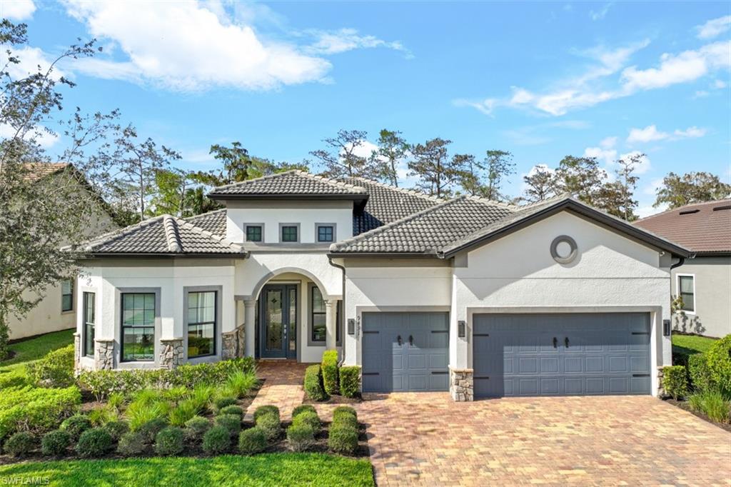 9431 Greyhawk Trail Naples, FL 34120 - Photo 2 of 50 a front view of a house with a yard