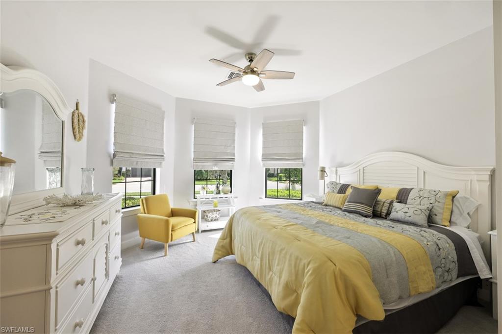 9431 Greyhawk Trail Naples, FL 34120 - Photo 21 of 50 a bedroom with a bed a chandelier and a couch