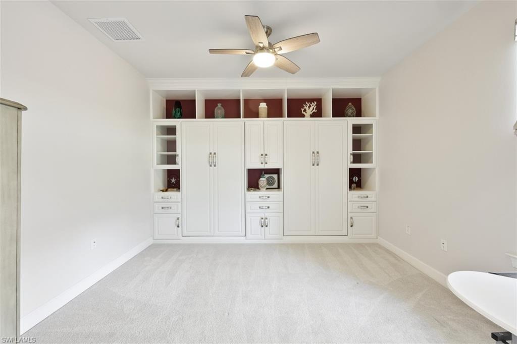 9431 Greyhawk Trail Naples, FL 34120 - Photo 26 of 50 an empty room with windows