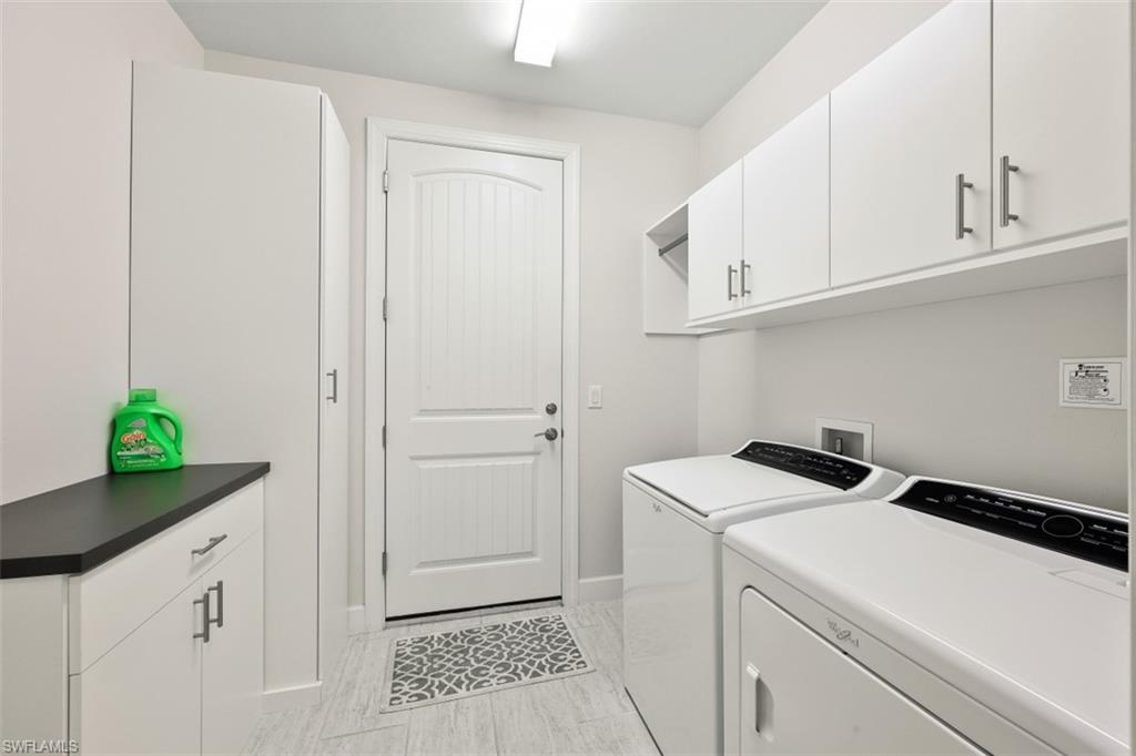 9431 Greyhawk Trail Naples, FL 34120 - Photo 27 of 50 a utility room with dryer and washer