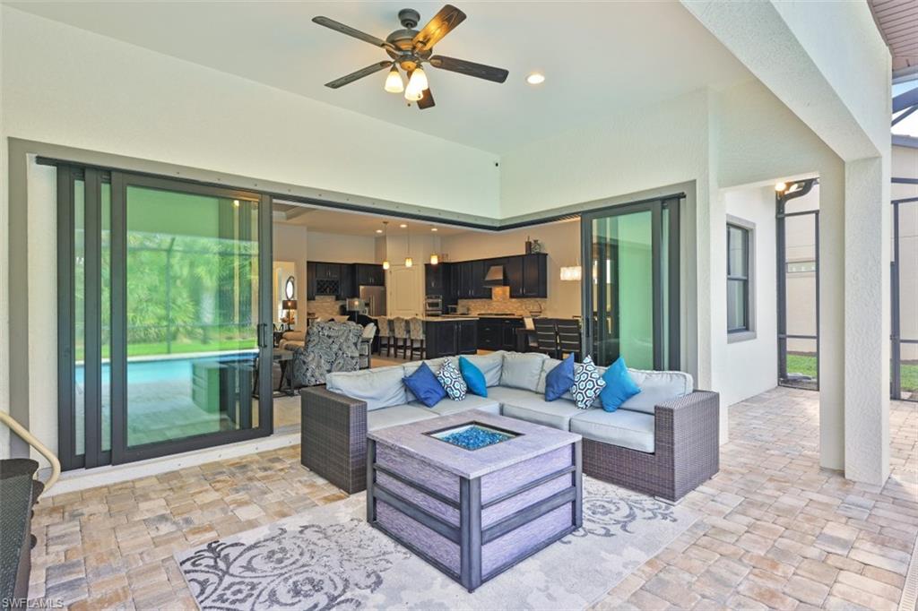 9431 Greyhawk Trail Naples, FL 34120 - Photo 28 of 50 a living room with furniture and a large window