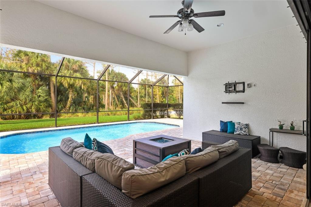 9431 Greyhawk Trail Naples, FL 34120 - Photo 30 of 50 a living room with couch and a floor to ceiling window